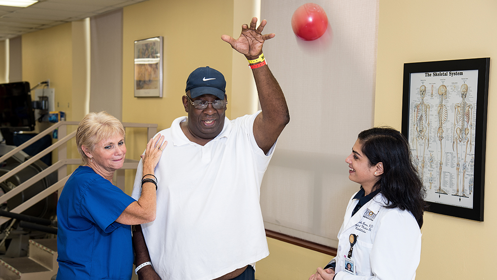 Therapist and physician working with a patient