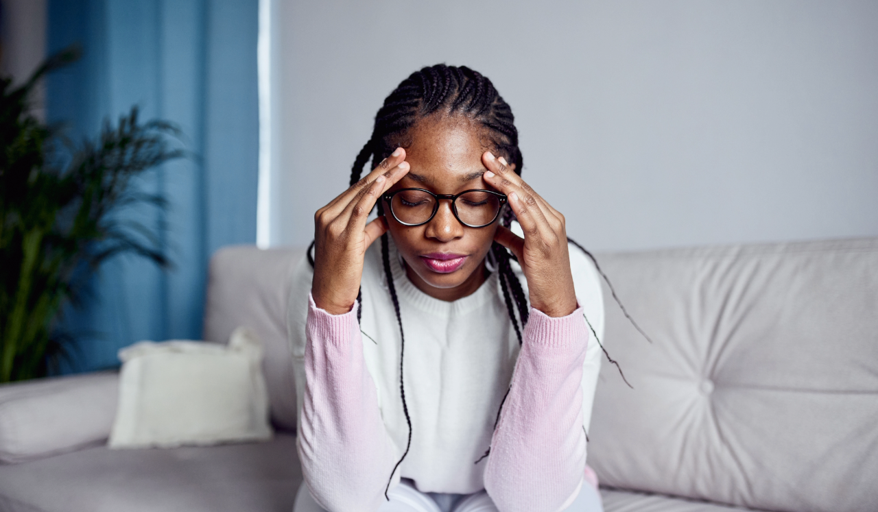 Woman rubbing her head from stress
