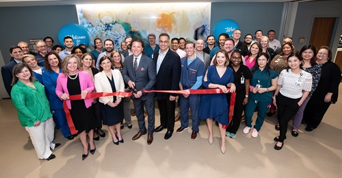Group of people cutting ribbon