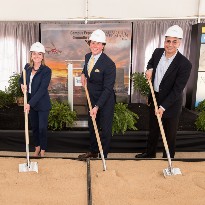 Three people digging dirt