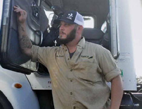 TIRR Memorial Hermann patient, Wes Brown, leans on his rig after returning to work.
