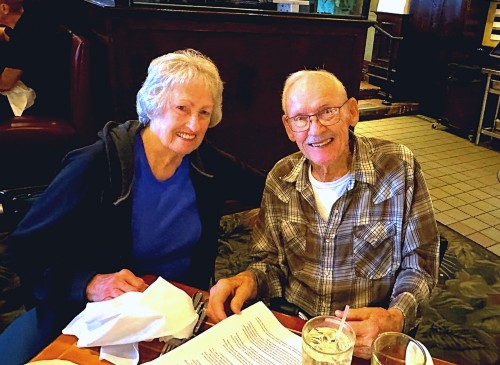 Cancer survivor, Deanna Owens smiles with her husband on a dinner date. 