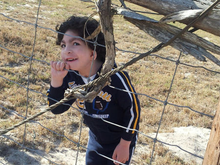 Cameron behind fence