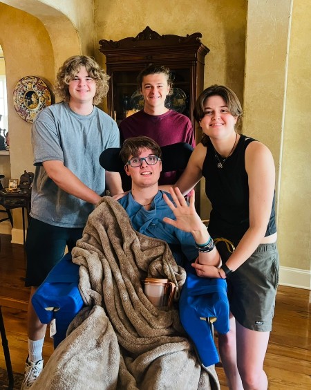TIRR Memorial Hermann patient, Davis Coker, smiles with his siblings.
