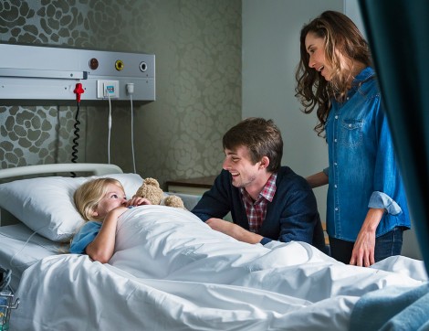 patient in hospital bed with parents