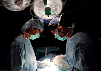 Doctor's performing surgery