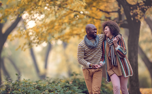 couple walking in fall forest