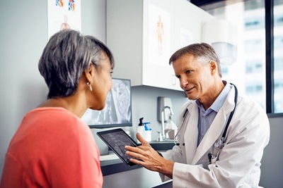 Doctor with female patient discussing x-ray