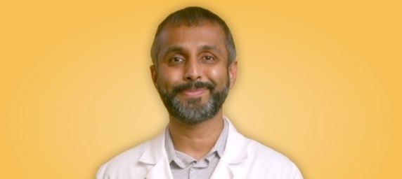 portrait of doctor in white coat on yellow background