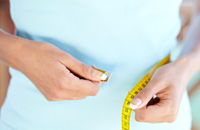 Woman measuring her waist