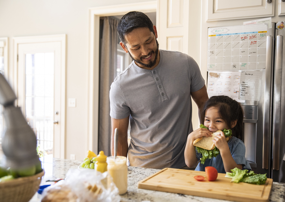 Father and daughter making a sandwich