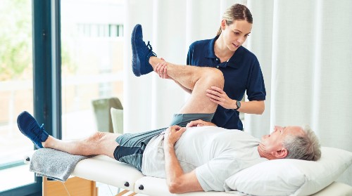 Physical Therapist working with patient