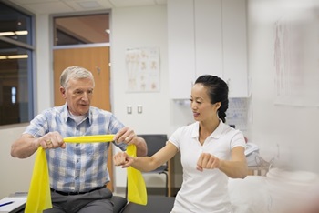 Old man participating in physical therapy