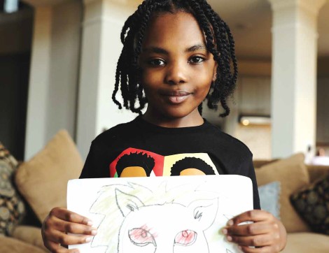 Former TIRR Memorial Hermann patient, Zion Walker, displays his artwork.