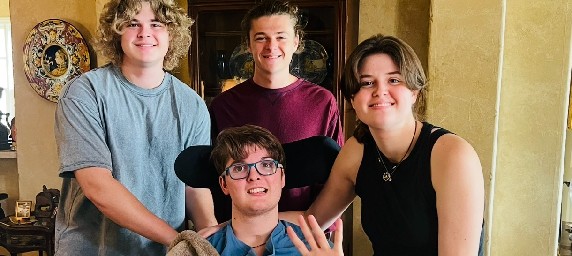 TIRR Memorial Hermann Neurobehavioral Program patient, Davis Coker, smiles with his three siblings.