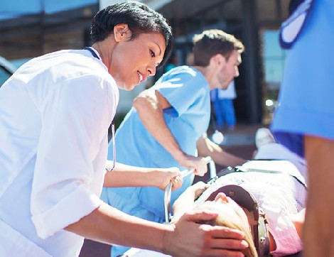 Doctor comforting patient on stretcher outside of hospital