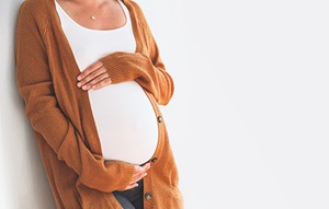 Mom holding pregnant belly