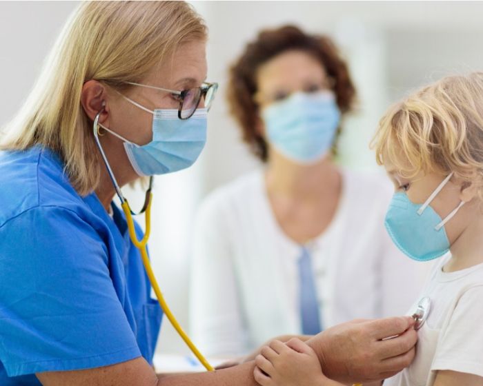 doctor with child patient wearing masks