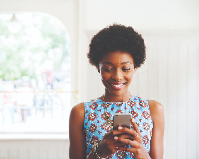 Woman smiling at her phone
