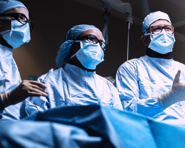 Three physicians in scrubs